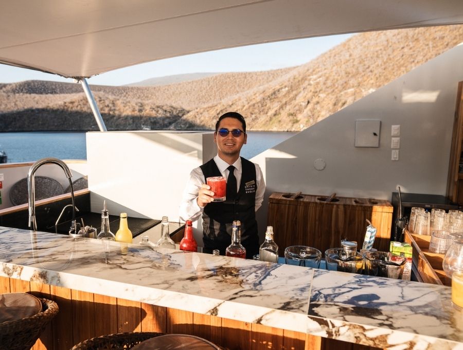 a bartender serving an exclusive drink in the galapagos